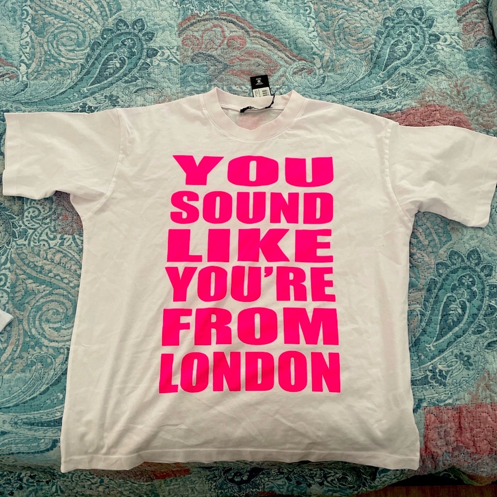White & pink tee. Size M could fit large . No need for it anymore